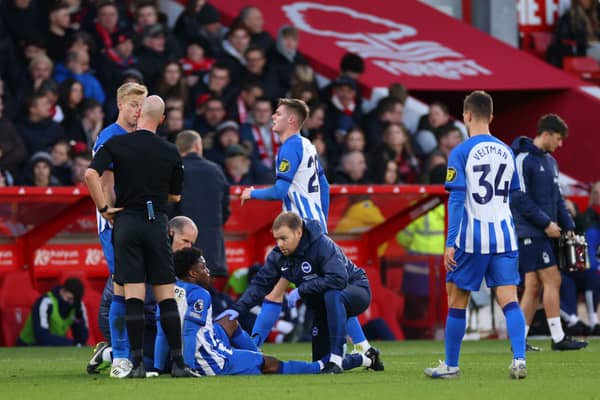  Tariq Lamptey of Brighton & Hove Albion receives medical treatment during the Premier League match between Nottingham Forest and Brighton & Hove Albion
