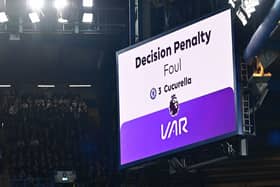The big screen displays the outcome of a VAR (Video Assistant Referee) review into a foul by Chelsea's Spanish defender #03 Marc Cucurella 