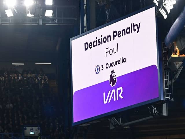 The big screen displays the outcome of a VAR (Video Assistant Referee) review into a foul by Chelsea's Spanish defender #03 Marc Cucurella 
