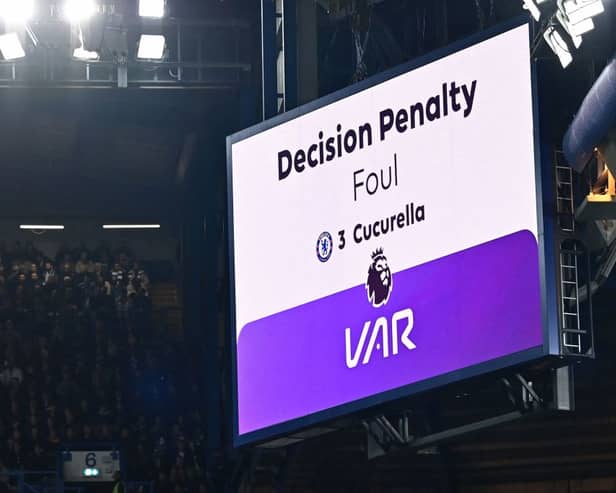 The big screen displays the outcome of a VAR (Video Assistant Referee) review into a foul by Chelsea's Spanish defender #03 Marc Cucurella 