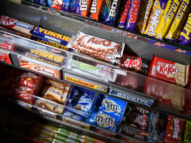 A selection of confectionary and chocolates on a newsagent shelf