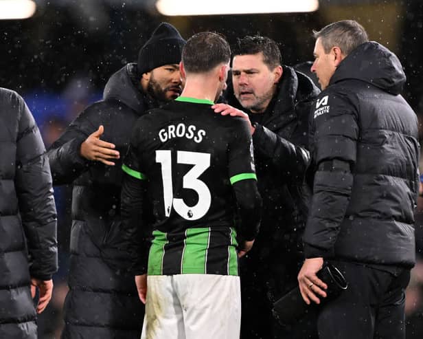 Pascal Gross of Brighton & Hove Albion talks to Mauricio Pochettino, Manager of Chelsea, following the Premier League match between Chelsea FC and Brighton & Hove Albion