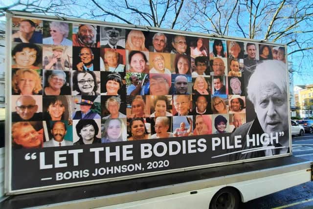 A mobile van displays a giant billboard of some of the victims of the Covid pandemic