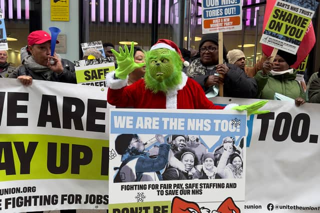 Unite's Grinch delivering a Christmas card for health secretary Victoria Atkins. (Photo by Arielle Goldstein)