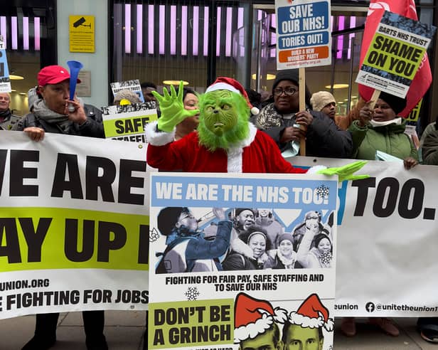 Unite's Grinch delivering a Christmas card for health secretary Victoria Atkins. (Photo by Arielle Goldstein)