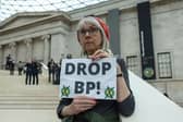 An activist in April 2023 holds a sign that says 'Drop BP!' at the British Museum. (Photo by Hollie Adams/Getty Images)