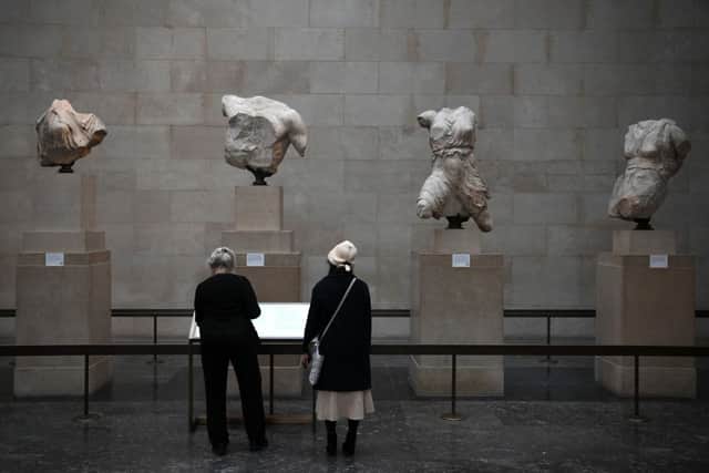 Visitors view the Parthenon Marbles, also known as the Elgin Marbles, at the British Museum in January 2023. (Photo by DANIEL LEAL/AFP via Getty Images)