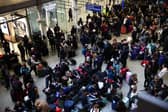 Passengers await news of Eurostar departures at St Pancras station in London on Saturday December 30, as services are cancelled due to flooding. (Photo by Henry Nicholls/AFP via Getty Images)