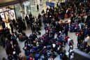Passengers await news of Eurostar departures at St Pancras station in London on Saturday December 30, as services are cancelled due to flooding. (Photo by Henry Nicholls/AFP via Getty Images)