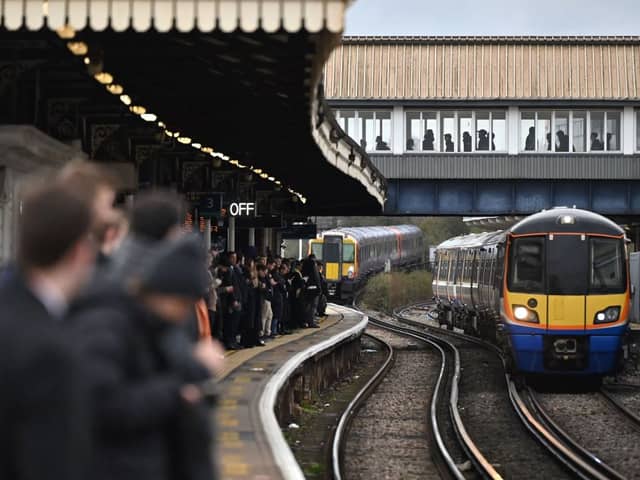 Commuters crowd on a platform at Clapham Junction station in south London. (Photo by JUSTIN TALLIS/AFP via Getty Images)