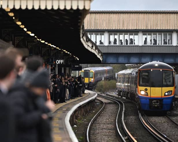 Commuters crowd on a platform at Clapham Junction station in south London. (Photo by JUSTIN TALLIS/AFP via Getty Images)
