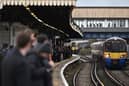 Commuters crowd on a platform at Clapham Junction station in south London. (Photo by JUSTIN TALLIS/AFP via Getty Images)