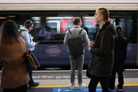 Commuters wait for a TfL Elizabeth line train in London. (Photo by Daniel LEAL / AFP via Getty Images)