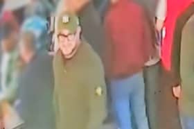 Police urge anyone who recognises the man in green, wearing a hat and glasses, to contact them