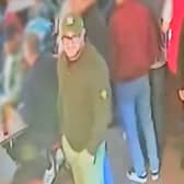 Police urge anyone who recognises the man in green, wearing a hat and glasses, to contact them