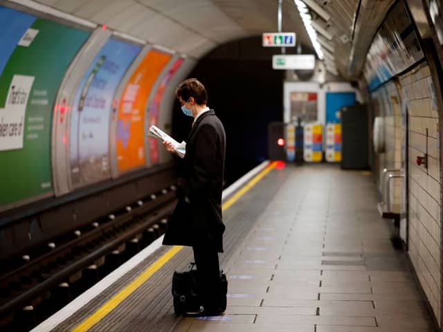 A lone commuter on a Tube platform. (Photo by TOLGA AKMEN/AFP via Getty Images)