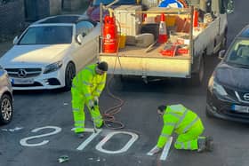 The word 'slow' spelled backwards on a street in Penge, south London,