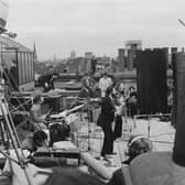 The Beatles performing their last live public concert on the rooftop of the Apple Corps building for director Michael Lindsey-Hogg's film documentary, Let It Be, in Savile Row, London, on January 30, 1969. Ringo Starr drums while Paul McCartney, John Lennon and George Harrison form the front line. Lennon's wife, Yoko Ono, sits on the right.