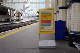 An "industrial action" sign on a London train platform.