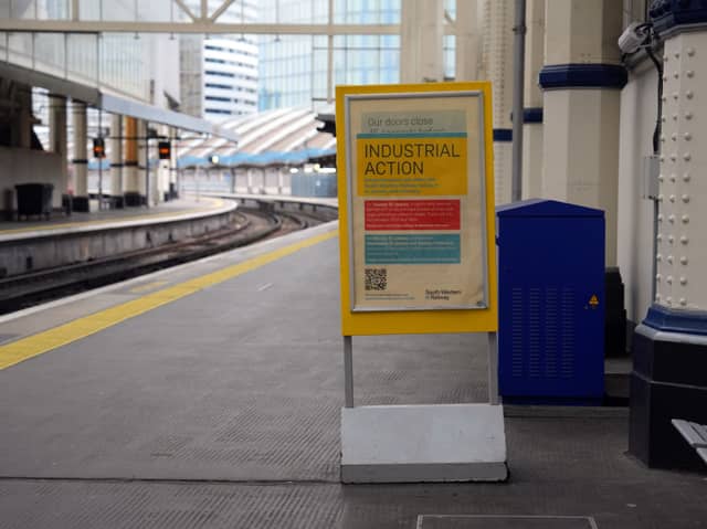 An "industrial action" sign on a London train platform.
