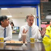 Prime Minister Rishi Sunak and UK Chancellor Jeremy Hunt have a drink and biscuits as they speak with employees during a visit to a London warehouse on March 6. 