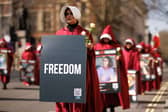 Protesters dressed as handmaids from The Handmaid's Tale march from Parliament Square to Iran's embassy to highlight repression of women in that country on March 8, 2024 in London, England. 