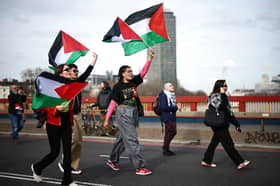 Pro-Palestinian activists and supporters march over Vauxhall Bridge