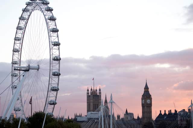 The sun sets beyond the Houses of Parliament and the London Eye in 2016.