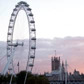 The sun sets beyond the Houses of Parliament and the London Eye in 2016.