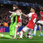 Arsenal celebrate after David Raya saves match-winning penalty in last 16 penalty shoot-out