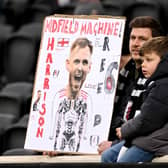 One young Fulham fans shows love to Harrison Reed.