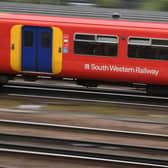 South Western trains travel past Clapham Junction station.