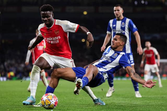 Bukayo Saka (L) is tackled by Porto's Galerno in UEFA Champions League quater-final