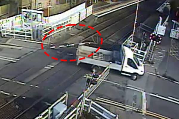 The van smashed through the level crossing barrier and dragged it along.