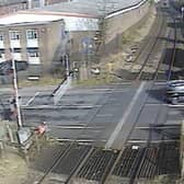 A car ignoring the signals and crossing the other side of the road to quickly dodge the closing barriers (Langley Green level crossing, West Midlands).  