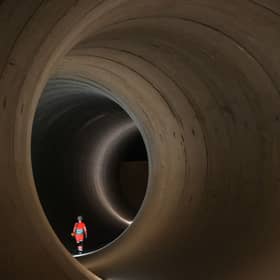 A civil engineer walks inside a 7 metre concrete tunnel at the Thames Tideway building site, in west London.