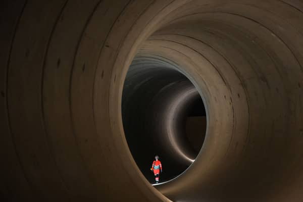 A civil engineer walks inside a 7 metre concrete tunnel at the Thames Tideway building site, in west London.