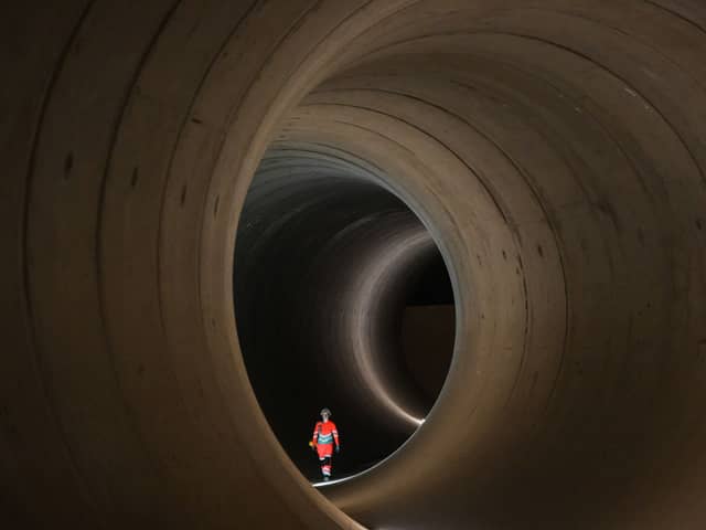 A civil engineer walks inside a 7 metre concrete tunnel at the Thames Tideway building site, in west London.