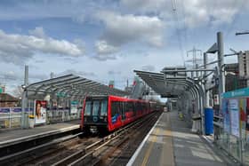 A TfL Docklands Light Railway (DLR) train comes into the platform.  