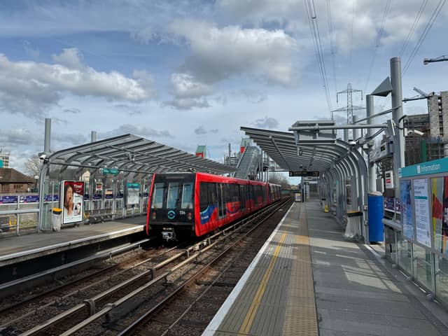 A TfL Docklands Light Railway (DLR) train comes into the platform.  