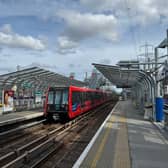 A TfL Docklands Light Railway (DLR) train comes into the platform.  