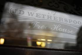 An etched window JD Wetherspoon logo. 