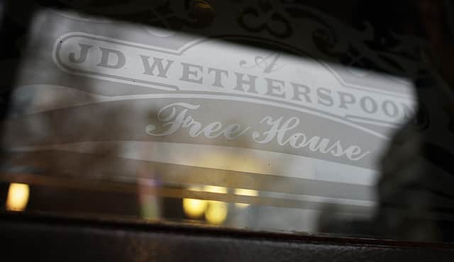 An etched window JD Wetherspoon logo.