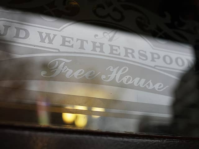 An etched window JD Wetherspoon logo. 