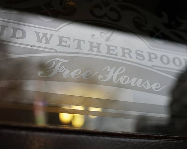 An etched window JD Wetherspoon logo. 