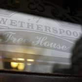 An etched window JD Wetherspoon logo. 