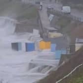 Huge waves and battering winds have washed newly-painted huts on Castle Beach, Falmouth, into the ocean.