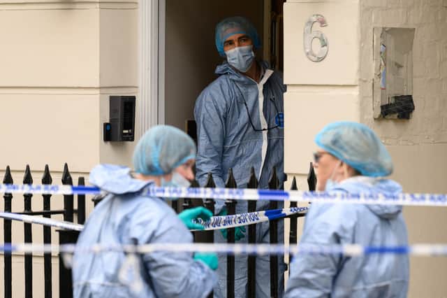 Members of the forensic search team are seen outside a residence near Hyde Park, London following the discovery of a woman's body.