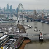 An aerial view shows snow-covered offices and buildings in central London.