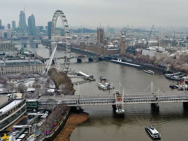 An aerial view shows snow-covered offices and buildings in central London.